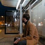 man waiting at a bus stop.