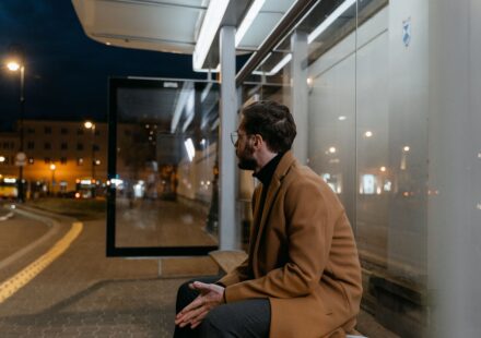 man waiting at a bus stop.